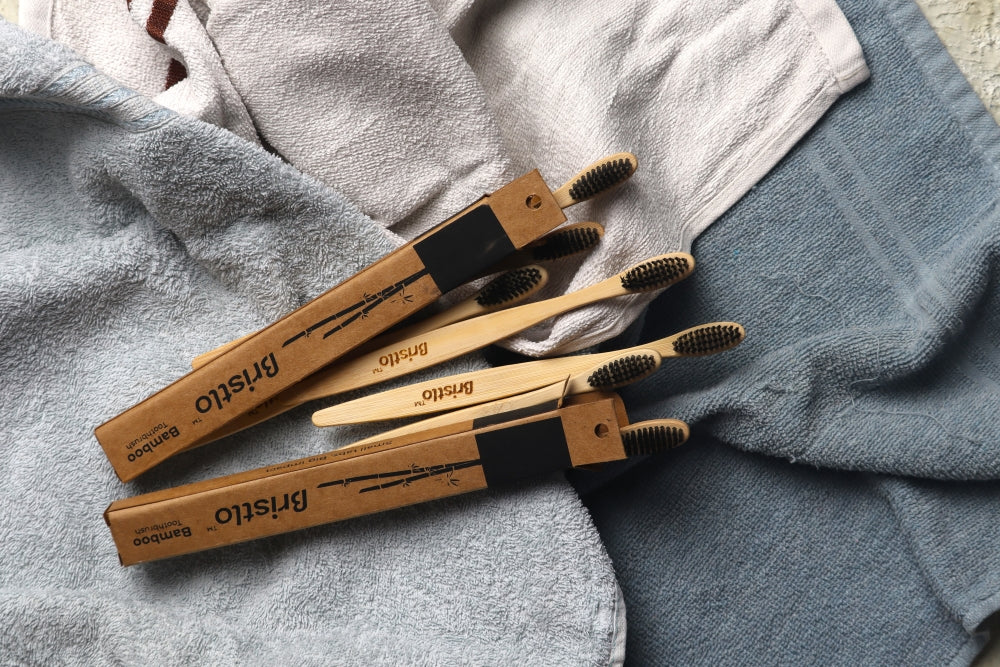 bristlo-bamboo-toothbrush-laying-on-top-of-towels